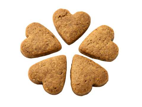 Heart-shaped natural brown dog biscuits, isolated PNG transparent background
