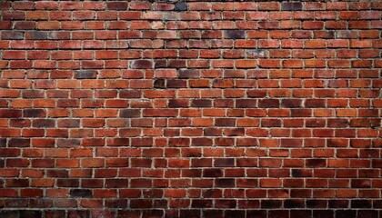 a textured red brick wall displaying various shades creating a rustic and warm atmosphere