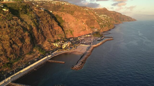 Aerial view of Calheta with artificial beach, marina and town at sunset, Madeira, Portugal.

