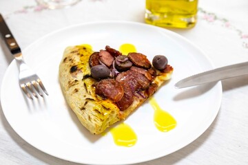 Delicious pizza slice with sausage and olives. Traditional Brazilian calabresa pizza 