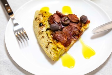 Delicious pizza slice with sausage and olives. Traditional Brazilian calabresa pizza 