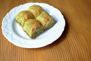 Traditional Turkish homemade baklava on white plate in close-up