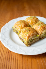Traditional Turkish homemade baklava on white plate in close-up
