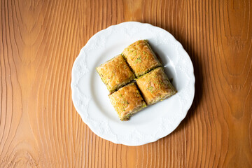 Traditional Turkish homemade baklava on white plate in close-up