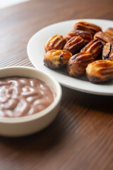 Close-up of churros dessert on a white vintage plate and hot chocolate