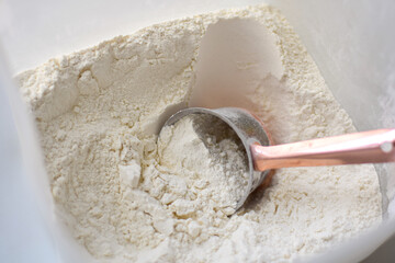 Measuring scoop inside flour container