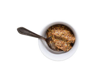 Whole grain dijon mustard in white bowl with old silver spoon isolated cutout on transparent