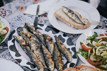 A grilled sardine on a slice of bread - traditional meal during the Saint Anthony festival 