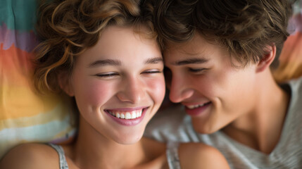 Joyful Young Couple Embracing on Bed with Colorful Bedspread