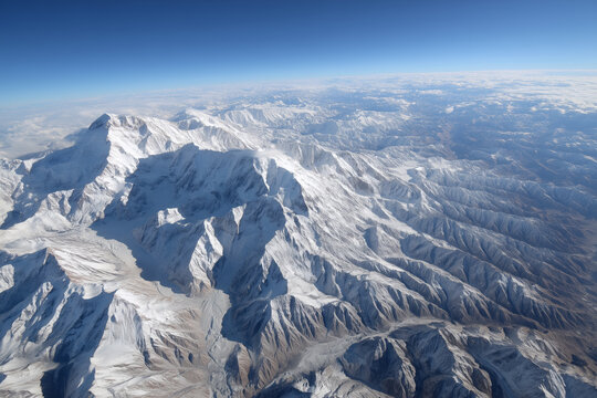 Aerial view of vast snow-covered mountain range