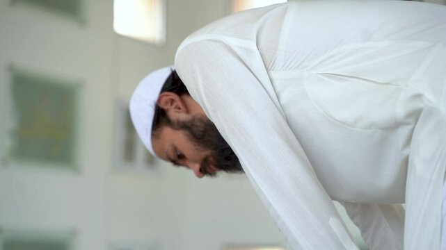 A Muslim man bowing down in deep prayer, connecting with his faith. Peaceful, spiritual moment.