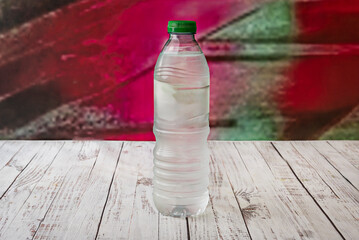 A clear plastic water bottle on a white table