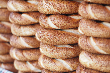 Freshly baked turkish simit stacked in a market display
