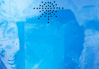 Painted blue iron door with ventilation holes close up abstract texture.