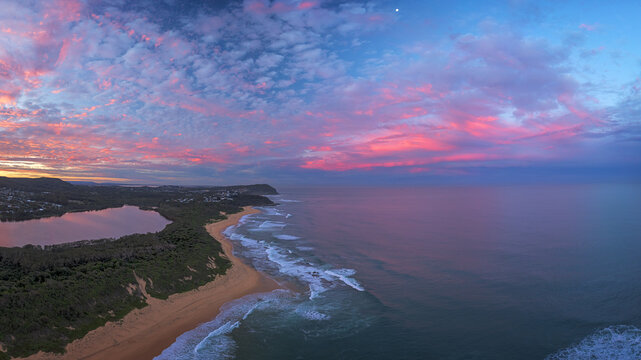 Beach and ocean panorama of beautiful colorful sky at sunset