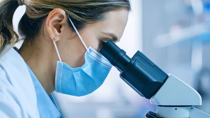 Female scientist in laboratory using microscope for research and analysis - Powered by Adobe