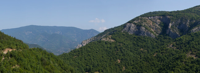 Rhodopes, are a mountain range in Southeastern Europe. Bulgaria. Panorama. The forest area covers the mountains.