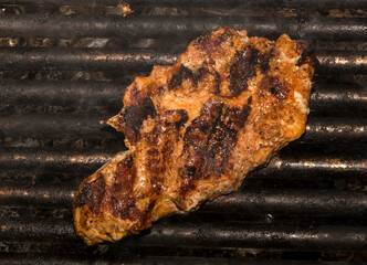 Roasting meat on the grill. Cooking fast food (barbecue) outside.