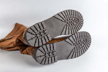 brown suede boots with black rubber soles and star tread pattern. Durable and stylish footwear