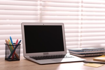 Fototapeta premium Workplace with laptop and stationery in office