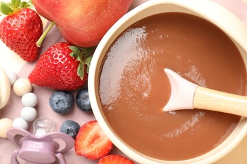 Baby food. Tasty puree in bowl, ingredients, pacifier and teether on table, flat lay