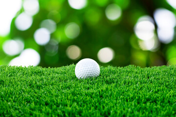 Golf ball on green grass outdoors, closeup