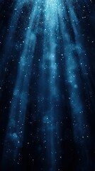 Streams of light pour down, illuminated dust particles floating. Beautiful deep blue and dark scene