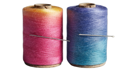 Two spools of colorful thread, a needle inserted in between
