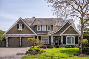 Two story stucco luxury house with nice spring blossom landscape in Vancouver, Canada, North America. Day time on May 2025.