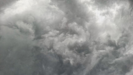 An intense shot of dark, swirling storm clouds filling the sky, evoking feelings of tension, turbulence, and the power of nature.