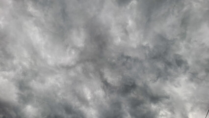 A stunning photo of a very overcast sky filled with thick, stormy clouds. The swirling formations and grey tones create a dramatic and atmospheric scene.