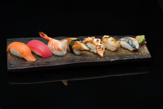 salmon, tuna, eel, aburi salmon, aburi scallop, kingfish, nigiri sushi on a plate 