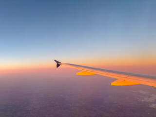Airplane wing window sunset