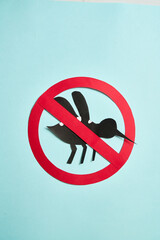 Hands holding No Mosquito sign for World Dengue Day awareness and prevention