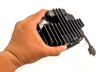 close up of hand holding the rear light housing of a motorcycle