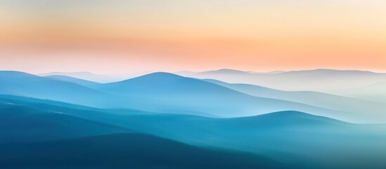 Misty mountain range at sunrise