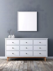 Empty frame on a gray wall above a white dresser.