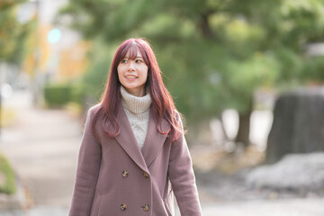 On a chilly December morning, a Japanese woman in her early twenties with long pink hair and a pink...