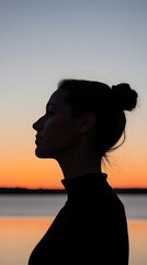 Silhouette of a woman at sunset.
