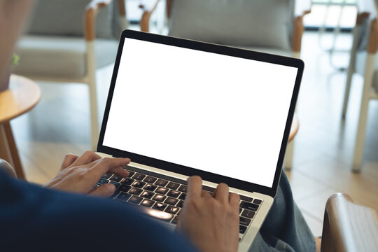 Mockup laptop with blank white screen. Young woman using laptop computer, working at coffee shop, empty screen, remote work, web template, for social media marketing, rear view