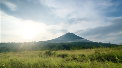 Fototapeta premium Misty mountain peak on a bright day