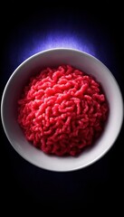 Ground meat in white bowl, dramatic lighting