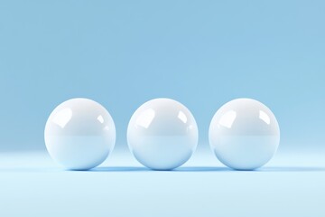 Three White Spheres on Blue - Three glossy white spheres arranged in a row against a light blue background. Simple, clean, and modern