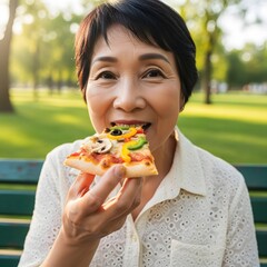 Joyful Senior Woman Enjoying Delicious Pizza Slice in a Park A Moment of Simple Pleasure