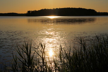 Sunset over the lake, boat on the water