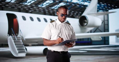 Smiling African American Airline Pilot © Andrey Popov