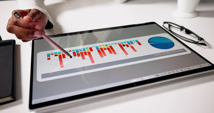 American Woman Using Laptop To Analyze Business Data