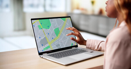 African-American Woman Browsing Real Estate Listings On Laptop