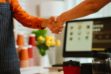 A smiling barista serves a customer at a modern café counter, showcasing friendly service, small business spirit, and coffee culture.