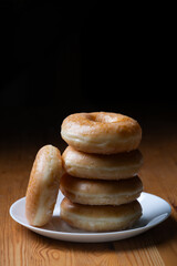 several donuts stacked on a plate